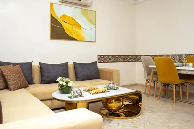 a living room with a couch and a table at Boho Haven Hivernage - Plein centre ville in Marrakech