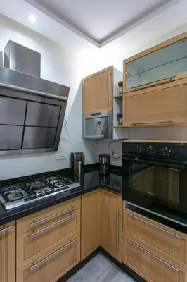 a kitchen with wooden cabinets and a stove top oven at A Touch of Marrakchi Magic - Marrakech in Marrakech
