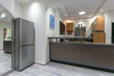 a large kitchen with a counter with a refrigerator at A Touch of Marrakchi Magic - Marrakech in Marrakech