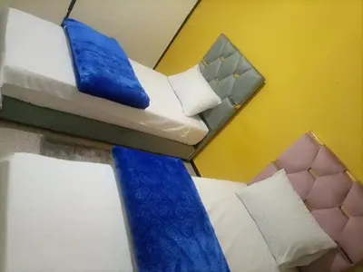 two beds in a room with blue ties on them at Your right choice in Marrakech