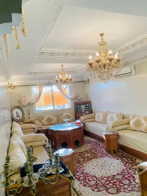 a living room with couches and a chandelier at beautiful apartment in Marrakech