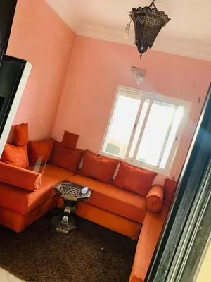 a living room with a couch and a window at beautiful apartment in Marrakech
