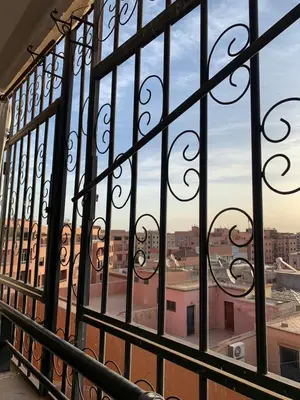 a window with a view of a city seen through it at beautiful apartment in Marrakech