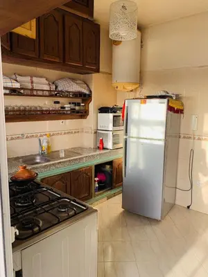 a kitchen with a white refrigerator and a stove at beautiful apartment in Marrakech