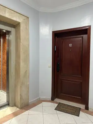 a wooden door in a room with a tile floor at Z-House -Heart of Gueliz and Steps from Everything in Marrakech