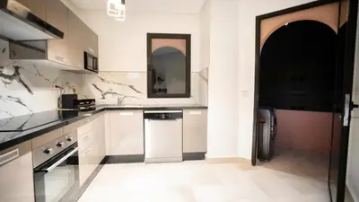 a kitchen with white cabinets and a black and white appliance at Home Lucini To Marrakech in Marrakech
