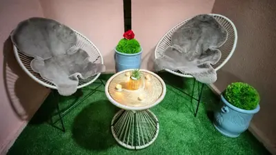 three chairs with a table and three plants in them at Home Lucini To Marrakech in Marrakech