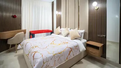 a bedroom with a bed and a chair in it at Home Lucini To Marrakech in Marrakech
