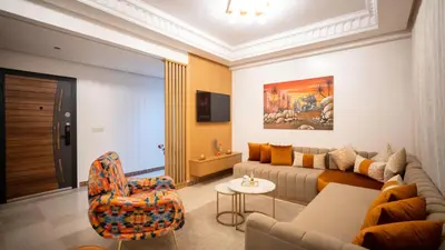 a living room with a couch and a chair at Home Lucini To Marrakech in Marrakech