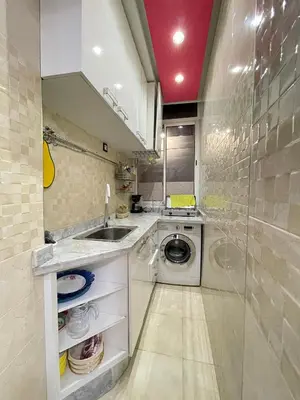 a kitchen with a washing machine and a sink at COZY Appartement in Marrakech