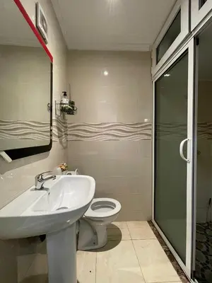 a bathroom with a sink and a toilet and a shower at COZY Appartement in Marrakech