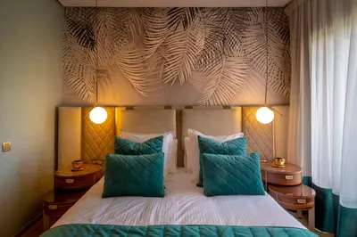a bedroom with a bed with two blue pillows at Appartement exceptionnel avec golf in Marrakech
