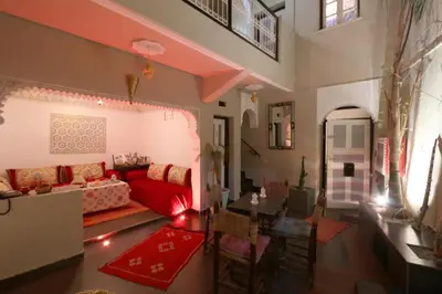 a living room with a red couch and chairs at Diamant La Ville Rouge in Marrakech