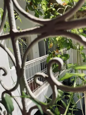 a view of a balcony through a wrought iron fence at Diamant La Ville Rouge in Marrakech
