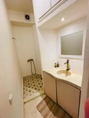 a bathroom with a sink and a mirror at Diamant La Ville Rouge in Marrakech