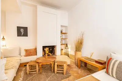 a living room with a couch and a table at Peaceful Oasis Authentic Riad in Marrakech
