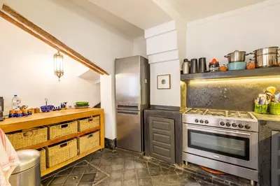 a kitchen with a stove and a counter at Peaceful Oasis Authentic Riad in Marrakech