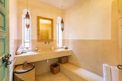 a bathroom with a sink and a mirror at Peaceful Oasis Authentic Riad in Marrakech