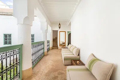 a porch with couches and a railing at Peaceful Oasis Authentic Riad in Marrakech