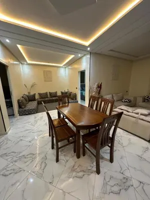 a living room with a wooden table and chairs at Maison meublé 3 pièces avec Piscine in Marrakech