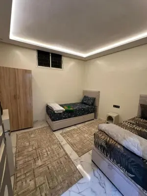 a room with two beds and a couch in it at Maison meublé 3 pièces avec Piscine in Marrakech
