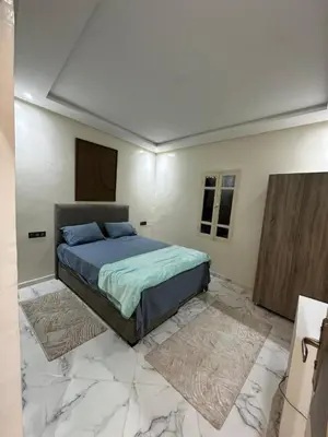 a bedroom with a bed in a room with marble floors at Maison meublé 3 pièces avec Piscine in Marrakech