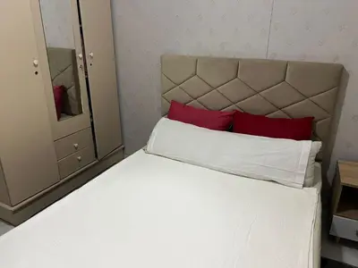 a bedroom with a white bed with red pillows at TerHouse in Marrakech