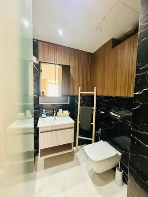 a bathroom with a toilet and a sink and a tub at Sompteux Appartement 1 chambre Piscine à Marrakech in Marrakech