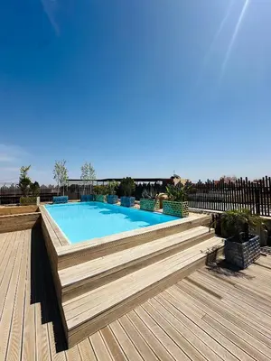 a swimming pool on top of a wooden deck at Sompteux Appartement 1 chambre Piscine à Marrakech in Marrakech