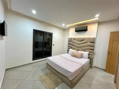 a bedroom with a bed and a tv on the wall at Immokesch1 in Marrakech
