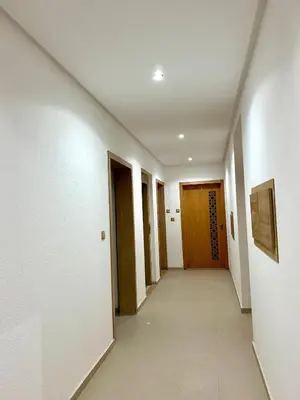 a hallway with white walls and wooden doors at Immokesch1 in Marrakech