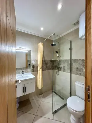 a bathroom with a shower and a toilet and a sink at Immokesch1 in Marrakech