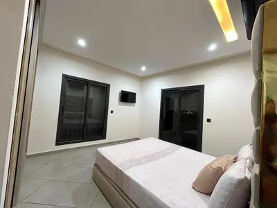 a bedroom with a bed and two windows at Immokesch1 in Marrakech