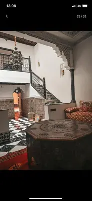 a living room with a staircase and a couch at Tourist Riad in Marrakech