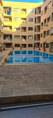 an empty swimming pool in front of a building at Love studio in Marrakech