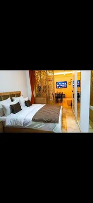 a bedroom with two beds and a dining room at Love studio in Marrakech
