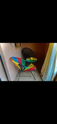 a colorful chair and a table in a room at Love studio in Marrakech
