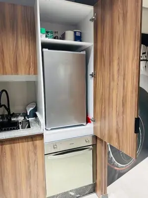 a kitchen with an open door of a small refrigerator at Sublime Appartement 1 chambre WIFI à Marrakech in Marrakech