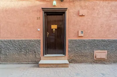 a black door on the side of a building at Riad SWAN-exclusif - Piscine chauffée - Petit déjeuner in Marrakech