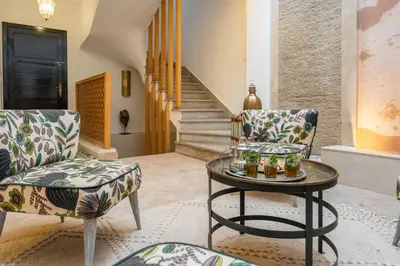 a living room with two chairs and a table at Riad SWAN-exclusif - Piscine chauffée - Petit déjeuner in Marrakech