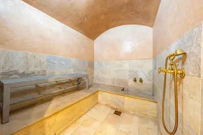 a bathroom with a shower and a bench at Riad SWAN-exclusif - Piscine chauffée - Petit déjeuner in Marrakech