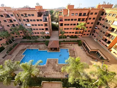 an overhead view of a pool in the middle of buildings at Calme et cozy avec piscine in Marrakech