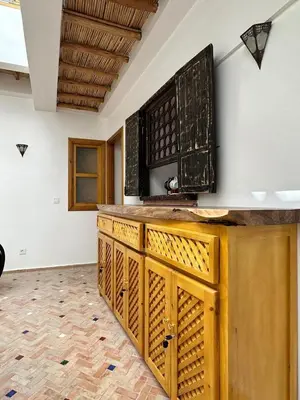a kitchen with a wooden counter top in a room at Riad Madinina in Marrakech