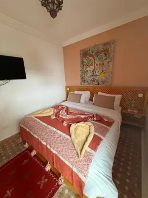 a bedroom with a large bed in a room at Riad Madinina in Marrakech