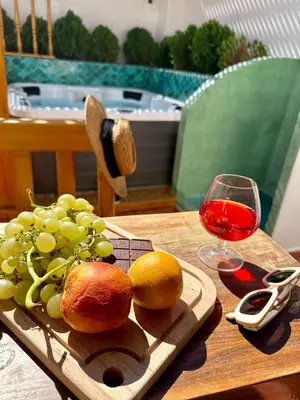 a plate of grapes and a glass of wine on a table at Riad Madinina in Marrakech