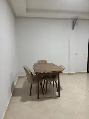 a wooden table and two chairs in a room at Petite villa cosy et agréable avec jacuzzi privé in Marrakech