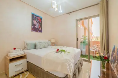 a bedroom with a bed and a window at L'Havre de paix de Guéliz au Coucher de Soleil in Marrakech