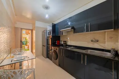 a kitchen with a sink and a dishwasher at L'Havre de paix de Guéliz au Coucher de Soleil in Marrakech