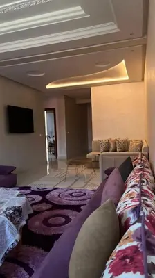 a living room with a couch and a television at Appartement de luxe en plein centre à Marrakech in Marrakech