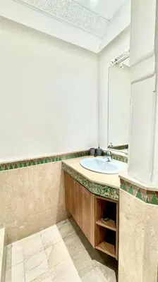 a bathroom with a sink and a mirror at Cozy apartment in city center in Marrakech